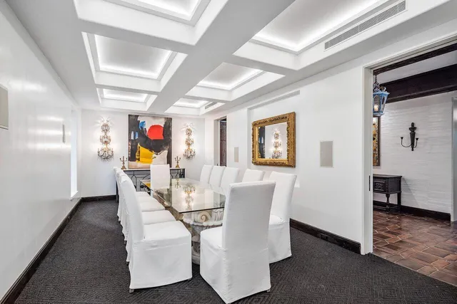 a view of a dining room with furniture wooden floor and a chandelier