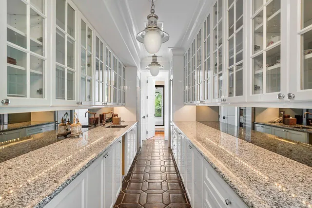 a large kitchen with stainless steel appliances granite countertop lots of counter top space and wooden floor