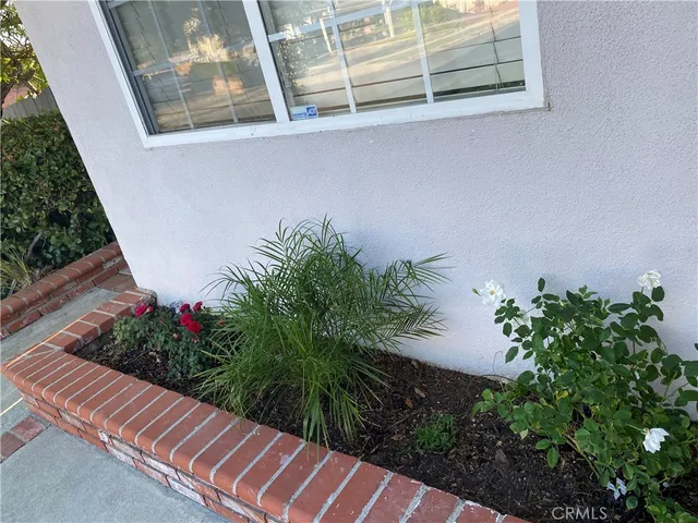 a vase with flowers sitting on a wooden floor