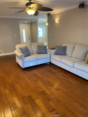 a living room with a couch and chandelier