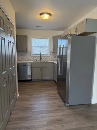 a kitchen with stainless steel appliances granite countertop a refrigerator and a sink