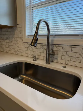 a kitchen with a sink and a window