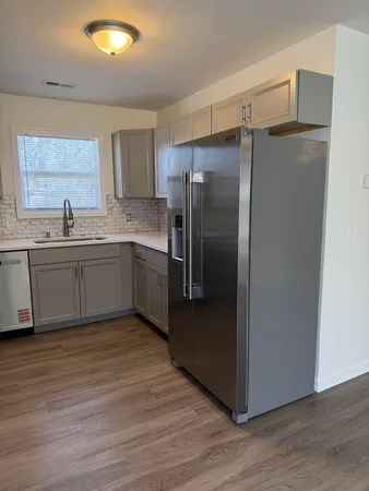 a kitchen with stainless steel appliances granite countertop a refrigerator and a sink