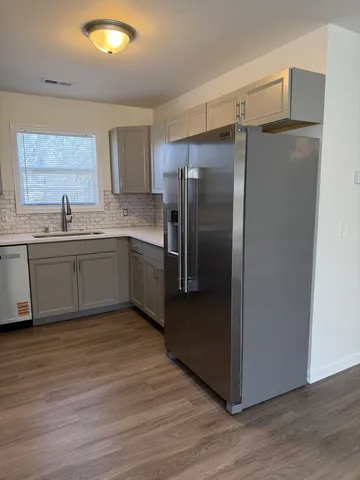 a kitchen with stainless steel appliances granite countertop a refrigerator and a sink