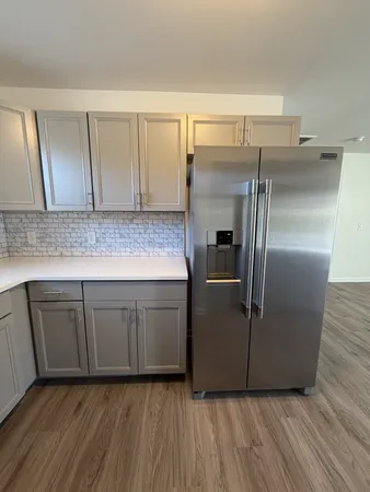 a kitchen with kitchen island a counter top space cabinets and stainless steel appliances