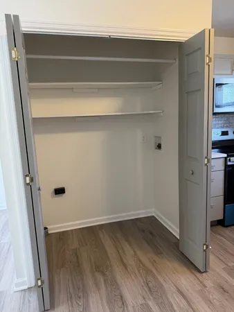 a view of storage and utility room with wooden floor