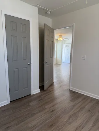 a view of a hallway with wooden floor