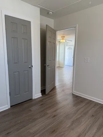 a view of a hallway with wooden floor
