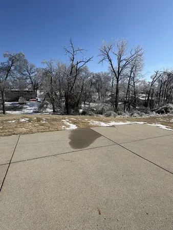 a view of a house with a snow on the road