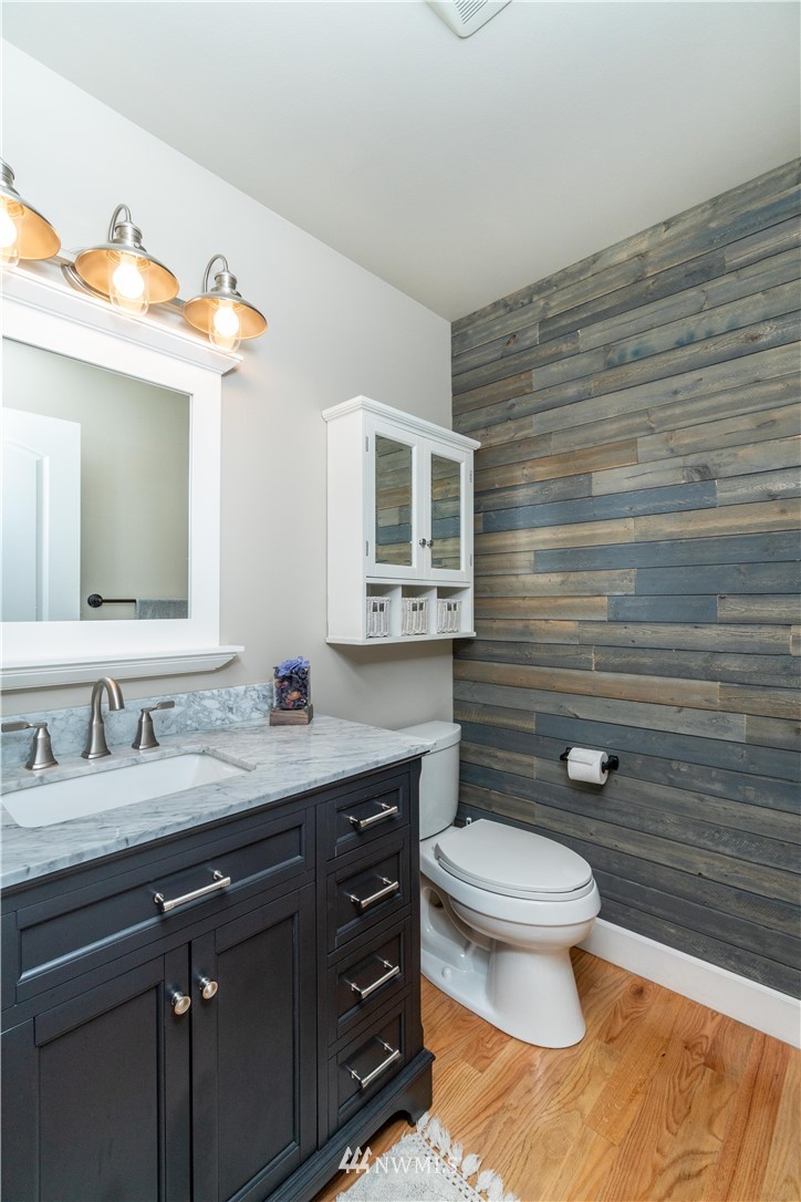 27515 Rose Road Arlington, WA 98223 - Photo 12 of 31 a bathroom with a granite countertop toilet sink and mirror