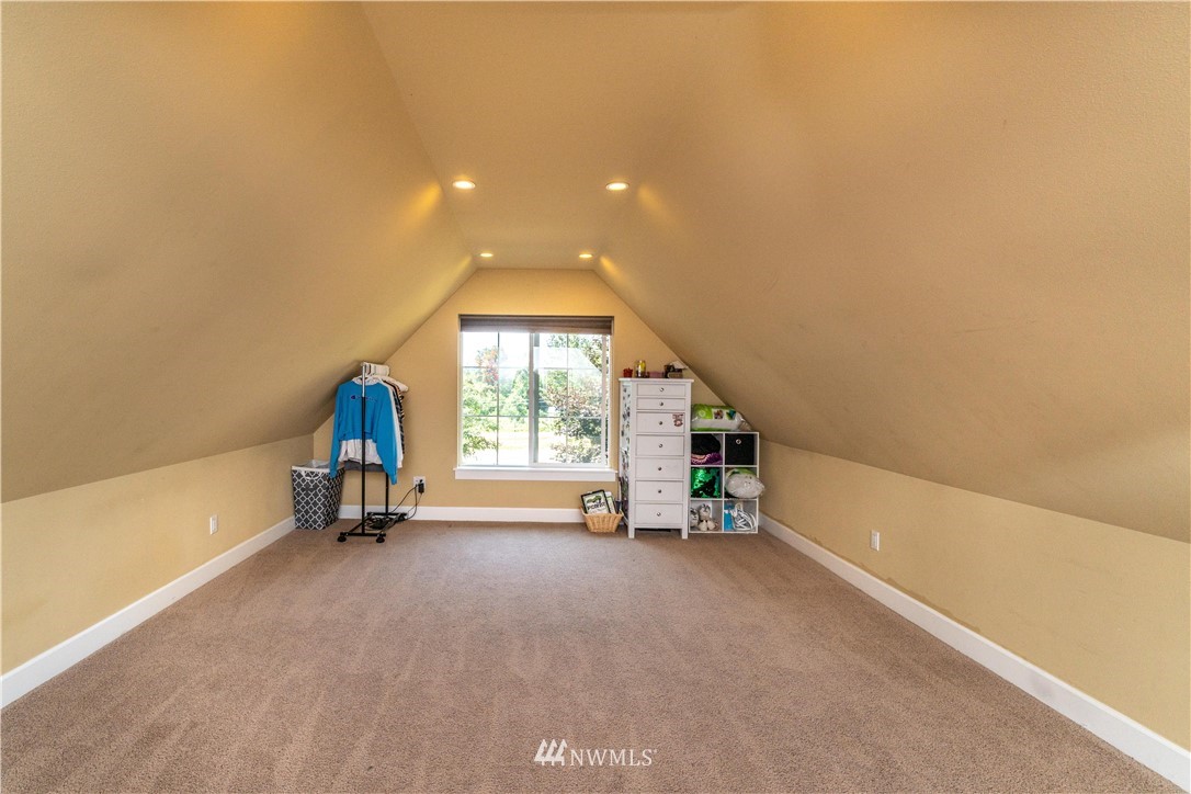 27515 Rose Road Arlington, WA 98223 - Photo 15 of 31 an empty room with a fireplace and a large window