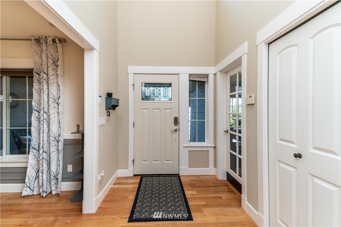 27515 Rose Road Arlington, WA 98223 - Photo 3 of 31 a view of a hallway with a room and front door