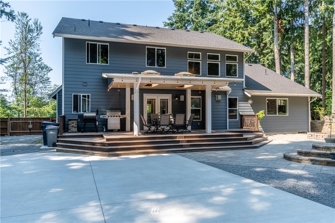 27515 Rose Road Arlington, WA 98223 - Photo 21 of 31 a view of a house with a patio and backyard