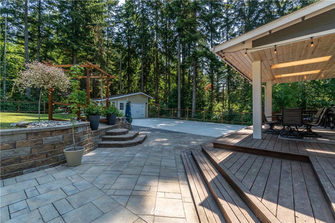 27515 Rose Road Arlington, WA 98223 - Photo 22 of 31 a view of a patio with chair and tables