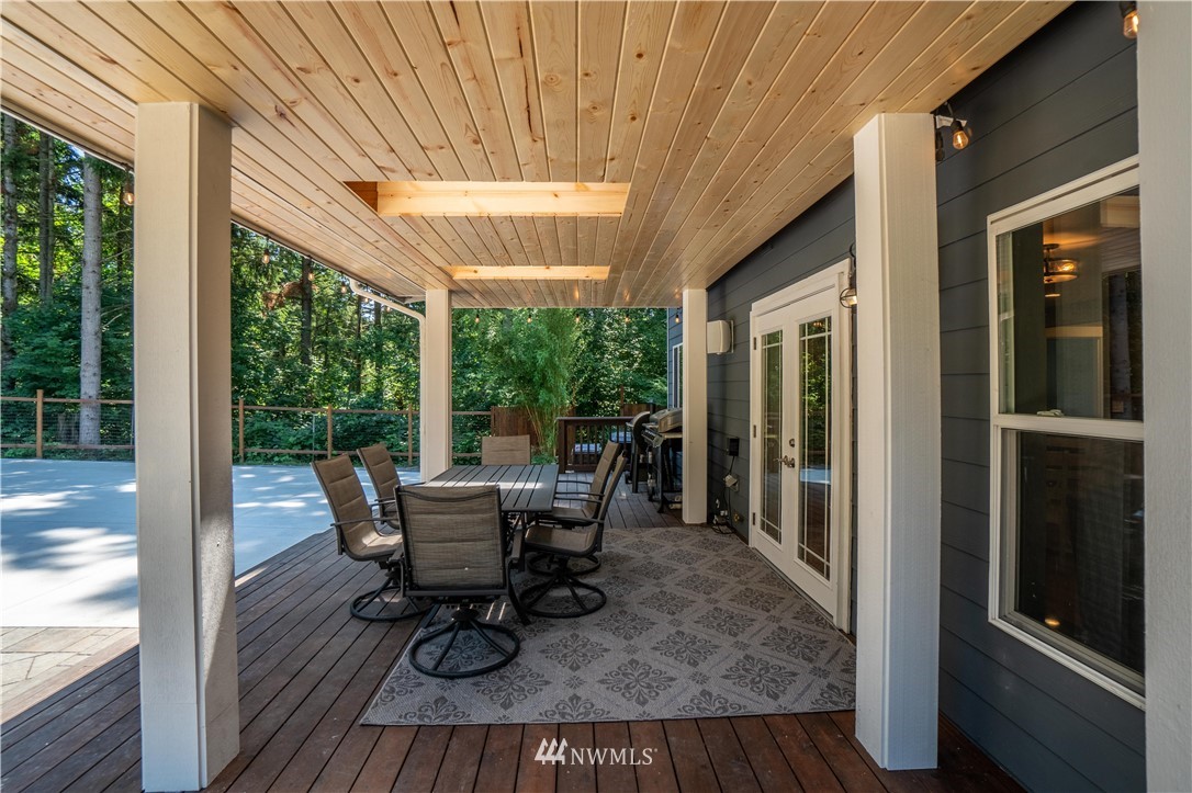 27515 Rose Road Arlington, WA 98223 - Photo 23 of 31 a dining room with furniture and wooden floor