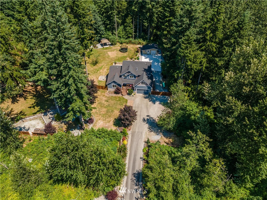 27515 Rose Road Arlington, WA 98223 - Photo 28 of 31 an aerial view of a house with a yard and trees all around