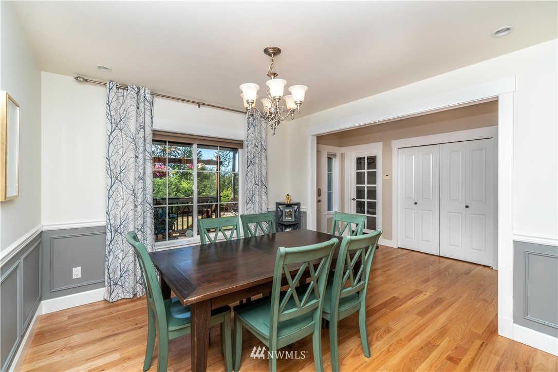 27515 Rose Road Arlington, WA 98223 - Photo 6 of 31 a dining room with furniture a rug and a chandelier
