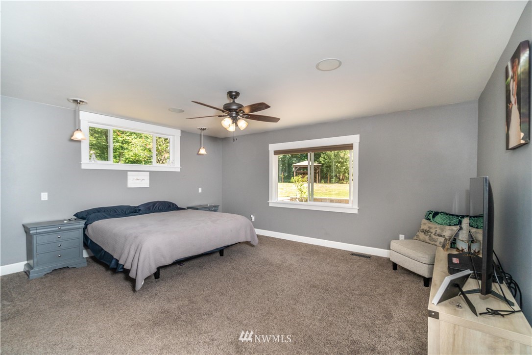 27515 Rose Road Arlington, WA 98223 - Photo 9 of 31 a living room with a bed furniture and a window