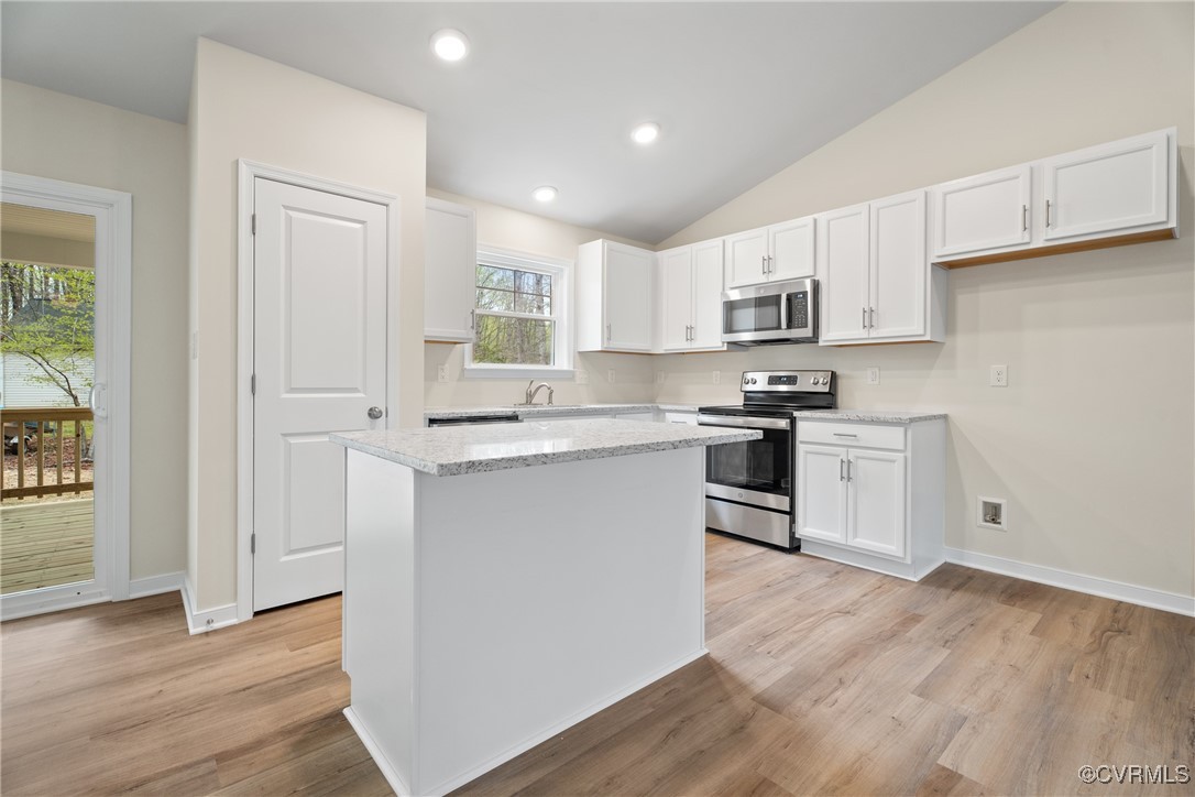 4865 Three Chopt Road Louisa, VA 23093 - Photo 6 of 14 a kitchen with white cabinets and stainless steel appliances