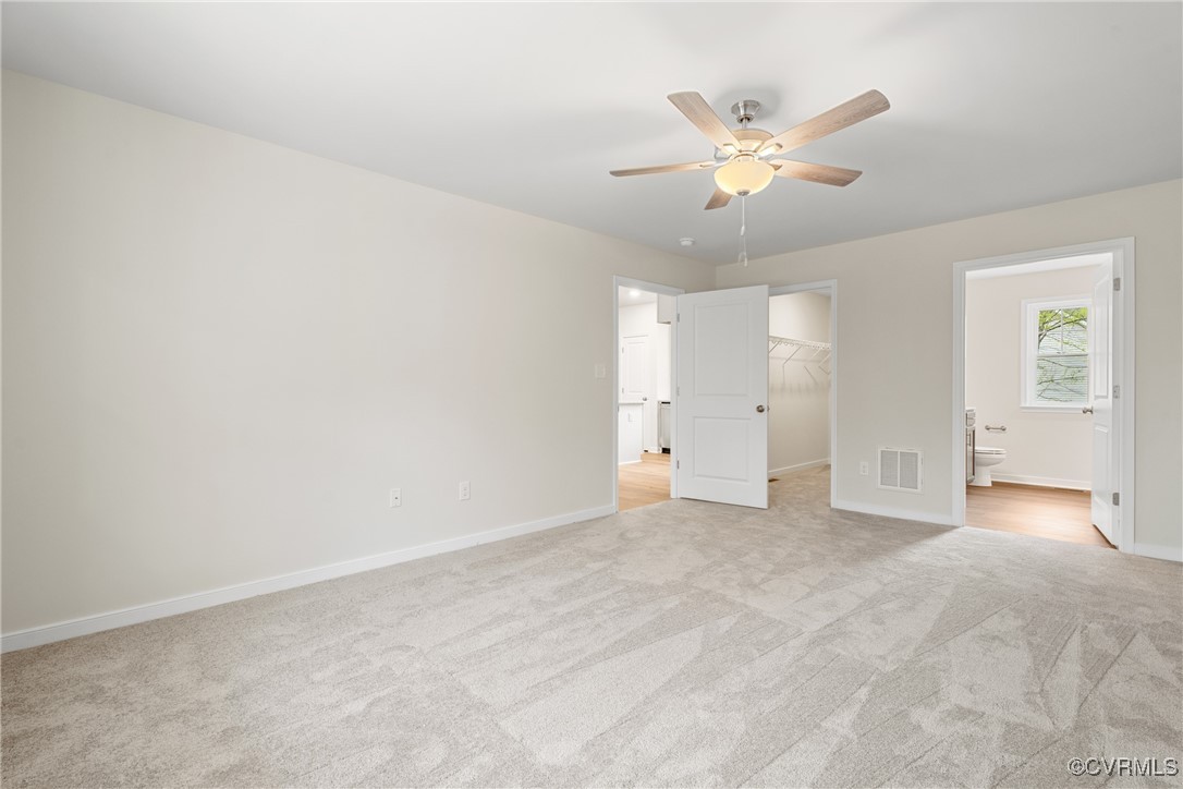 4865 Three Chopt Road Louisa, VA 23093 - Photo 9 of 14 an empty room with chandelier fan and windows