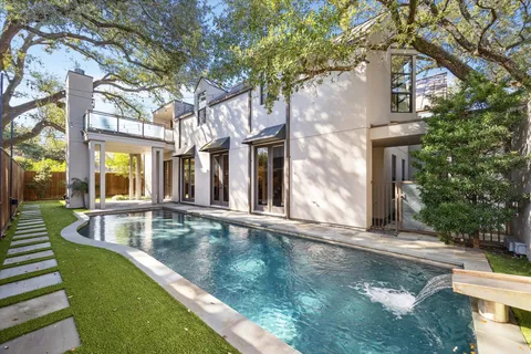 a view of a house with pool and sitting area