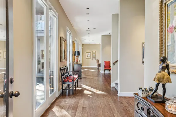 a view of a hallway view with wooden floor and staircase