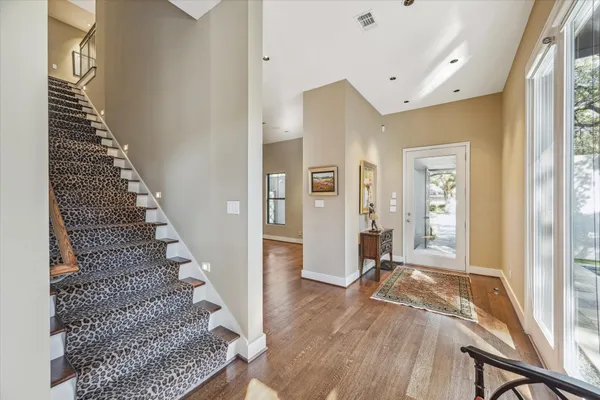 a living room with fireplace furniture and a wooden floor