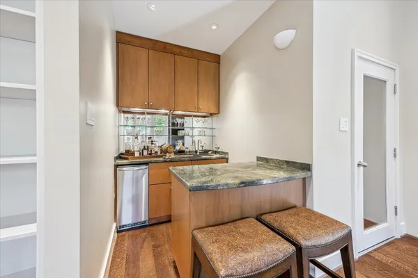 a kitchen with granite countertop a sink and a stove top oven with granite countertops
