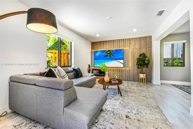 a living room with furniture and a potted plant