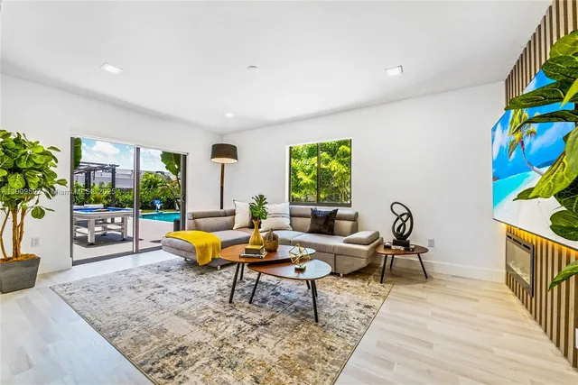 a living room with furniture and a potted plant