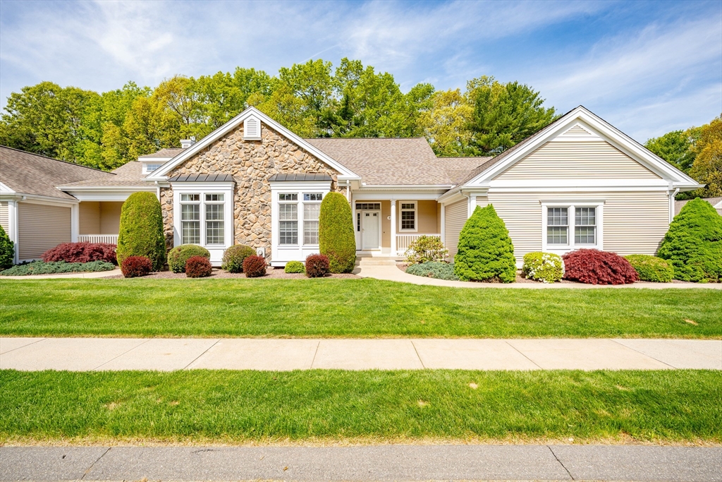 a front view of a house with a garden