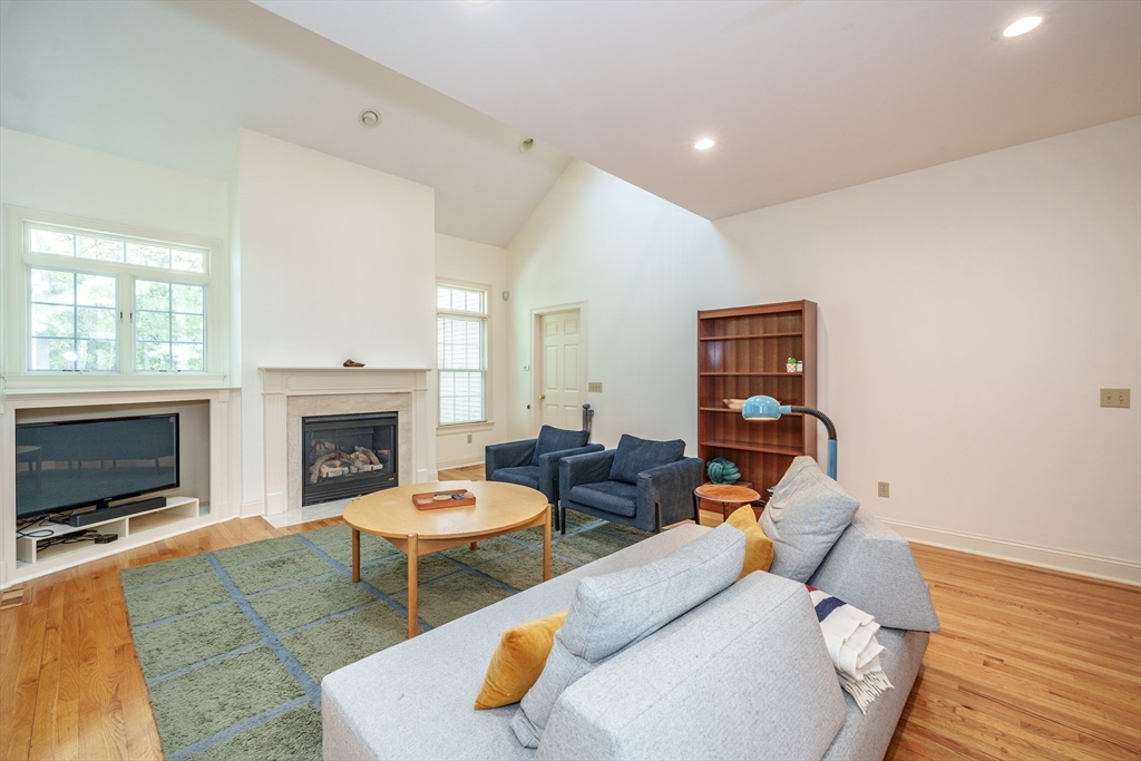 97 High Pine Circle, Unit 97 Wilbraham, MA 01095 - Photo 15 of 37 a living room with furniture a fireplace and a flat screen tv