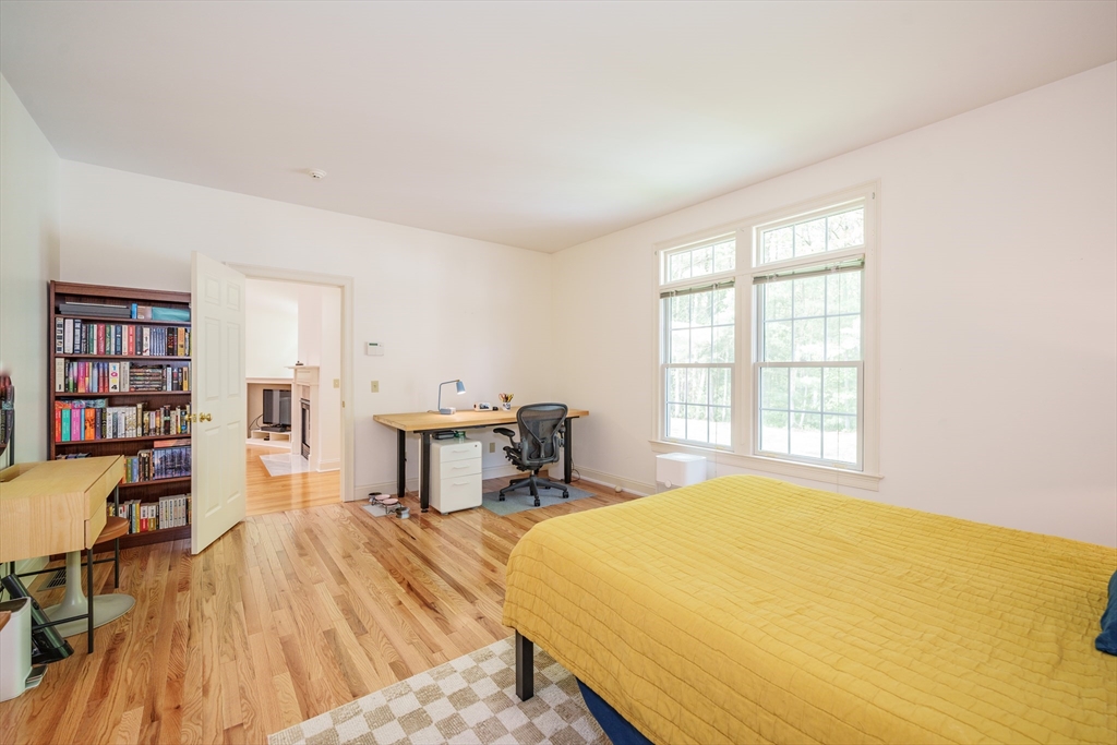 97 High Pine Circle, Unit 97 Wilbraham, MA 01095 - Photo 17 of 37 a spacious bedroom with a bed and a table in it