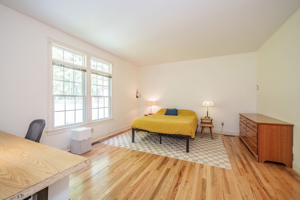 97 High Pine Circle, Unit 97 Wilbraham, MA 01095 - Photo 18 of 37 a bedroom with a bed and wooden floor