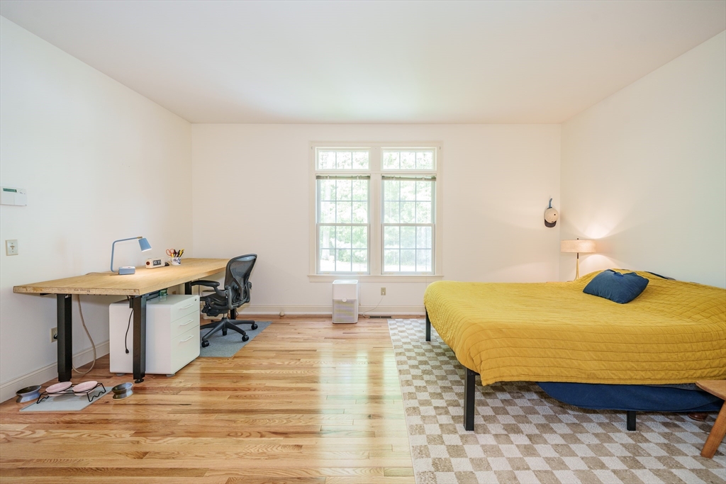 97 High Pine Circle, Unit 97 Wilbraham, MA 01095 - Photo 19 of 37 a bedroom with a bed and wooden floor