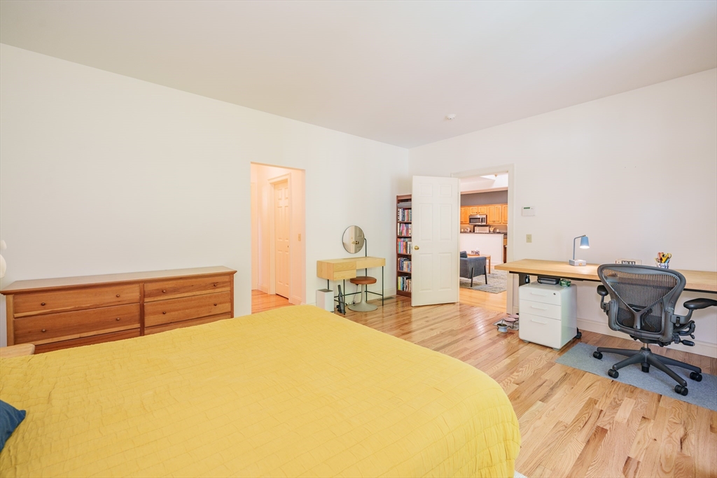 97 High Pine Circle, Unit 97 Wilbraham, MA 01095 - Photo 20 of 37 a bedroom with a bed and wooden floor