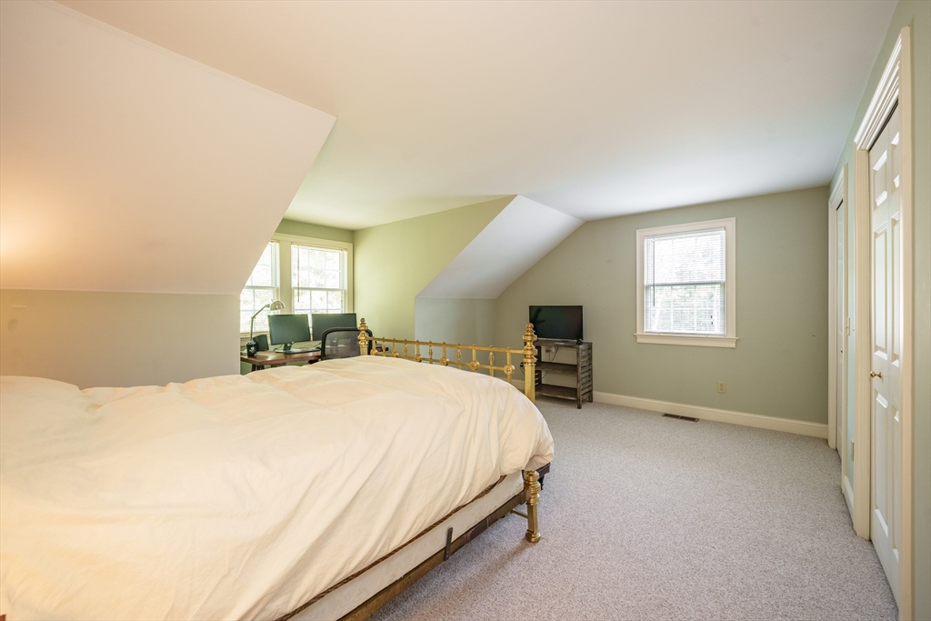 97 High Pine Circle, Unit 97 Wilbraham, MA 01095 - Photo 28 of 37 a spacious bedroom with a bed and a chair