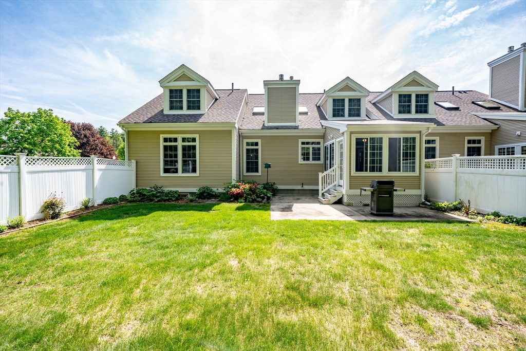 97 High Pine Circle, Unit 97 Wilbraham, MA 01095 - Photo 31 of 37 a front view of house with yard and trees in the background