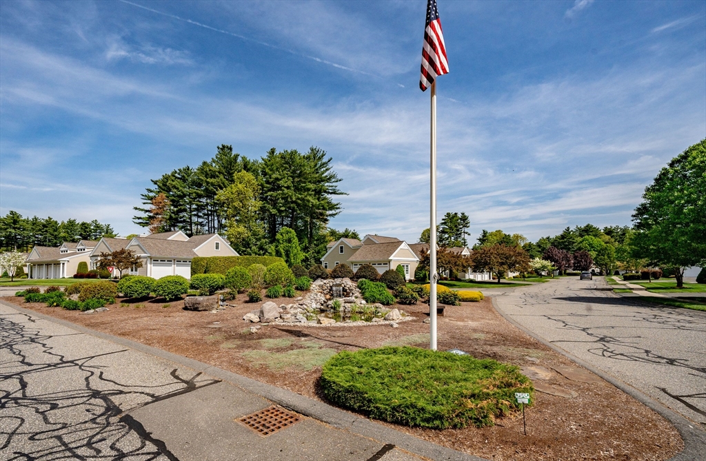 97 High Pine Circle, Unit 97 Wilbraham, MA 01095 - Photo 36 of 37 a street sign on a sidewalk next to a road