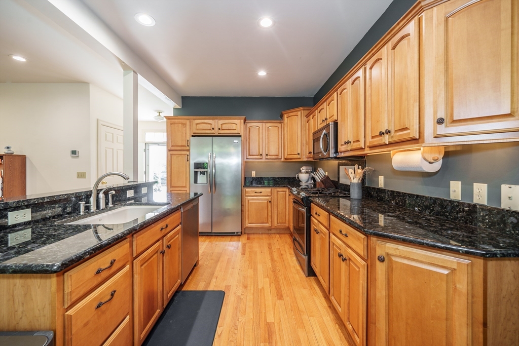 97 High Pine Circle, Unit 97 Wilbraham, MA 01095 - Photo 8 of 37 a kitchen with stainless steel appliances granite countertop a sink a stove and a refrigerator