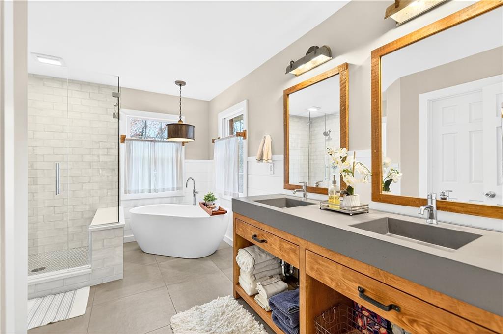 687 Old Millcreek Road Hookstown, PA 15050 - Photo 19 of 50 a spacious bathroom with a double vanity sink a mirror and a bathtub