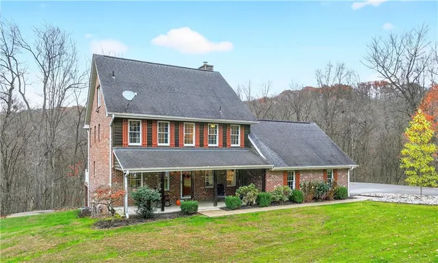 a front view of house with yard and green space