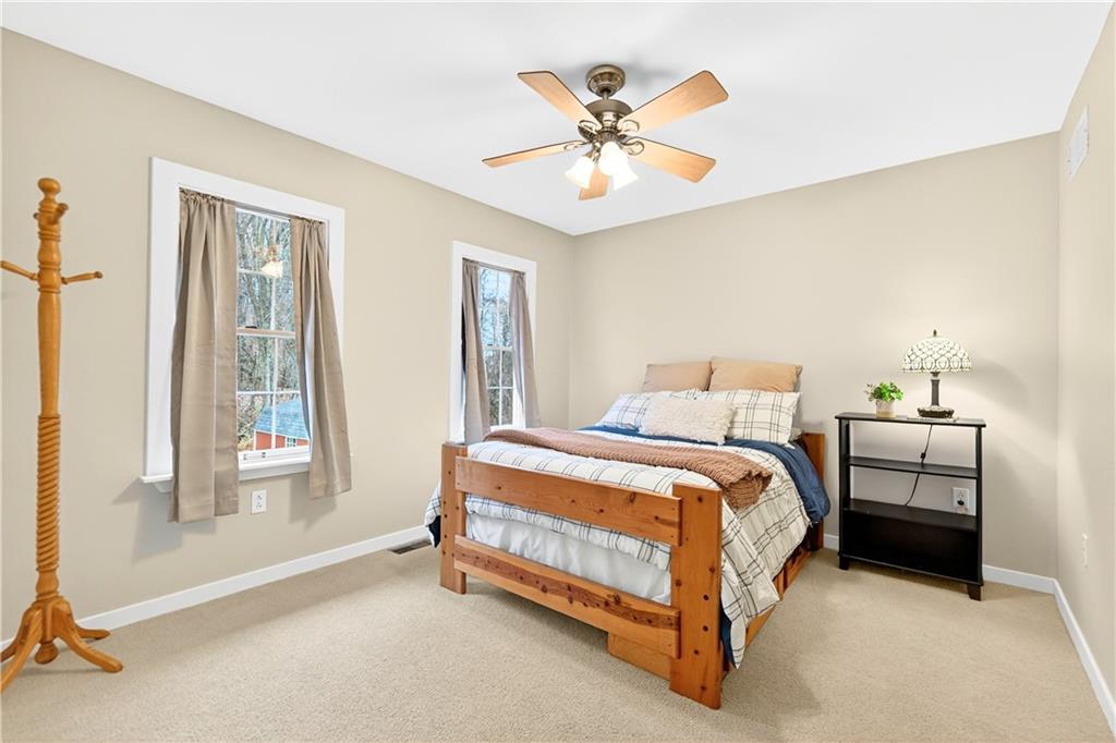 687 Old Millcreek Road Hookstown, PA 15050 - Photo 22 of 50 a spacious bedroom with a bed and a chandelier