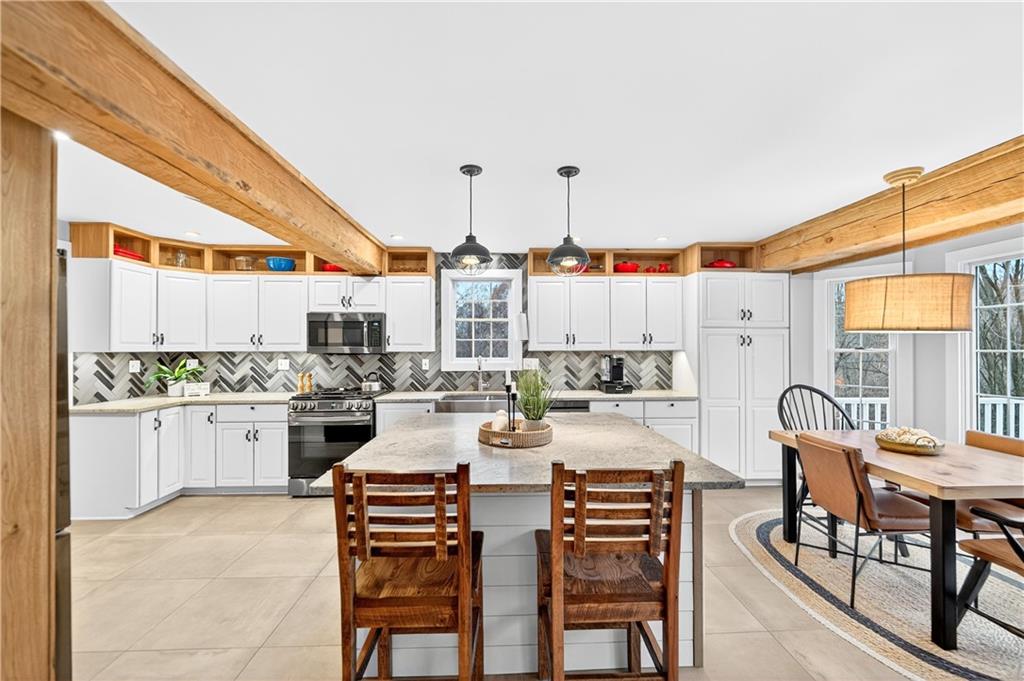 687 Old Millcreek Road Hookstown, PA 15050 - Photo 3 of 50 a kitchen with stainless steel appliances kitchen island granite countertop a table and chairs