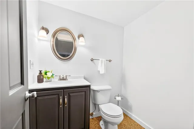 a bathroom with a sink a toilet and a mirror