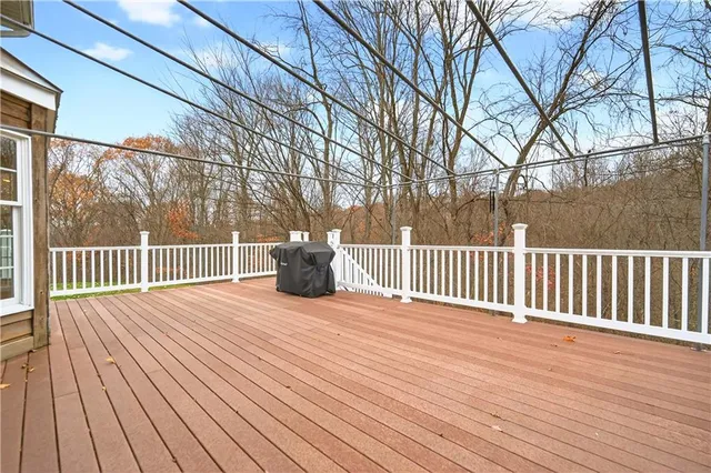 a view of a deck with wooden floor and fence