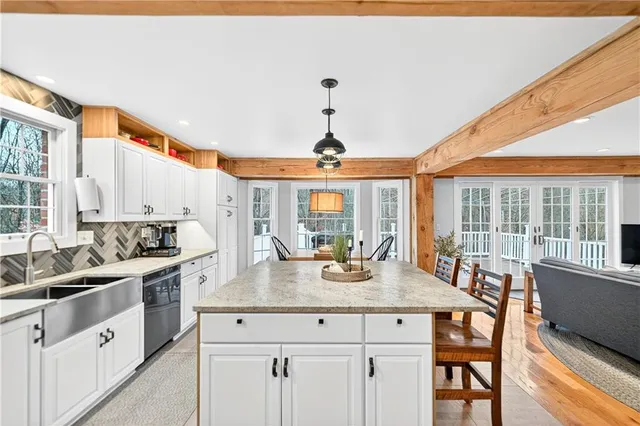 a kitchen with stainless steel appliances granite countertop a sink stove and cabinets