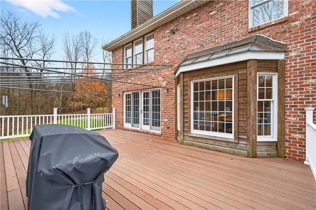 a view of a house with a large window and wooden fence