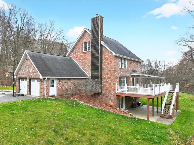 a front view of a house with a yard table and chairs