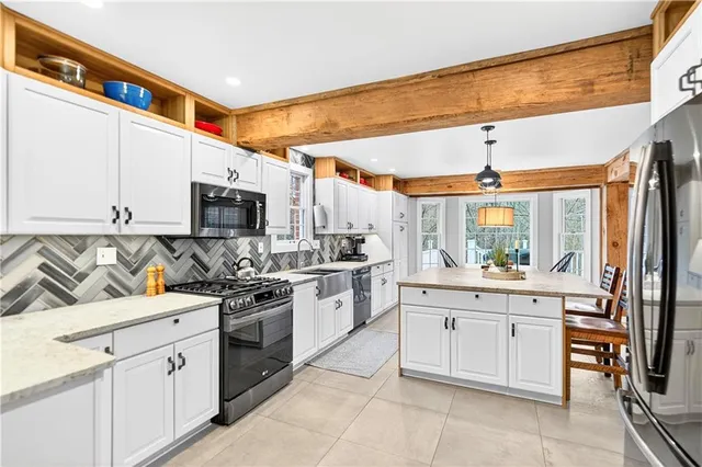 a kitchen with stainless steel appliances granite countertop a sink and cabinets